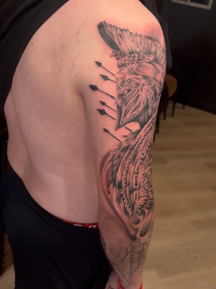 Spartan helmet tattoo by Giani Martini