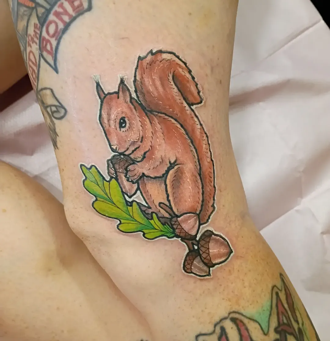 Squirrel and oak branch tattoo by Nolan Schneider