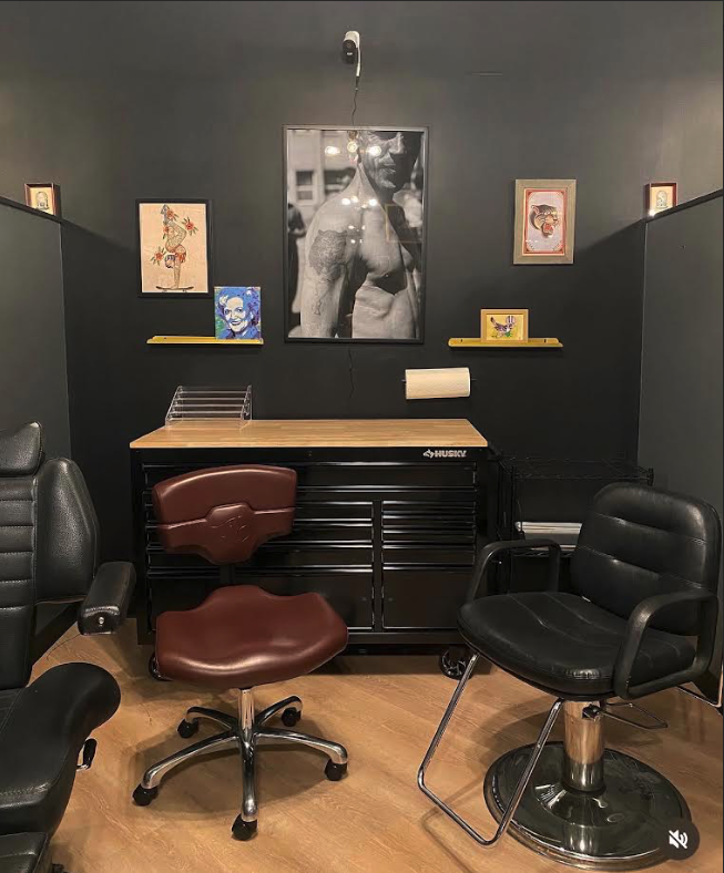 Tattoo station with chairs and framed artwork